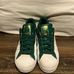 Green and White Adidas shoes with gold accents. Size 8 1/2 in Men’s.